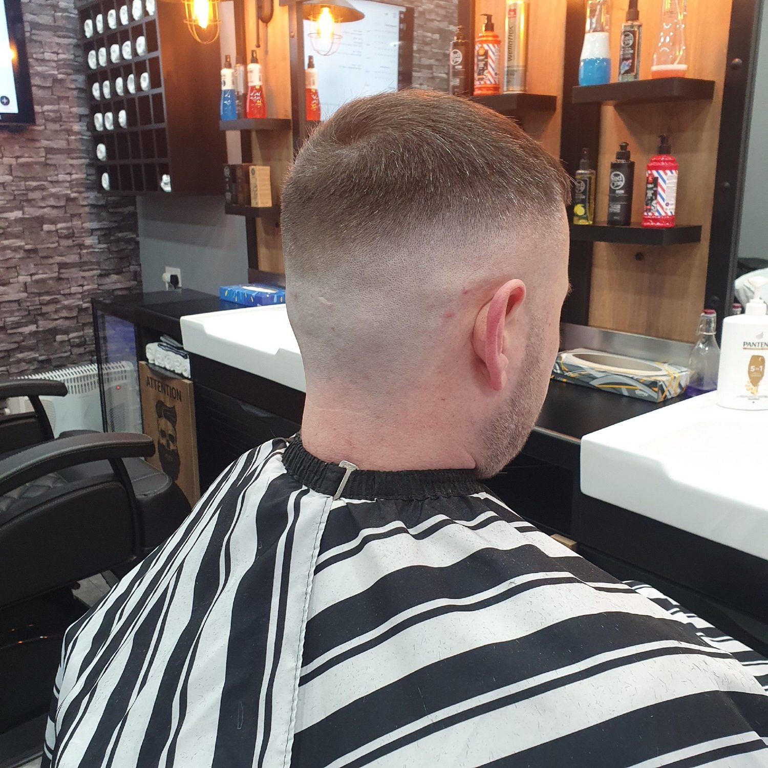 A skin fade from behind, product shelves beyond