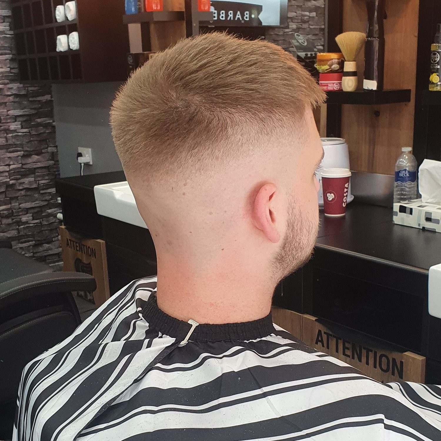 A blond skin fade from behind